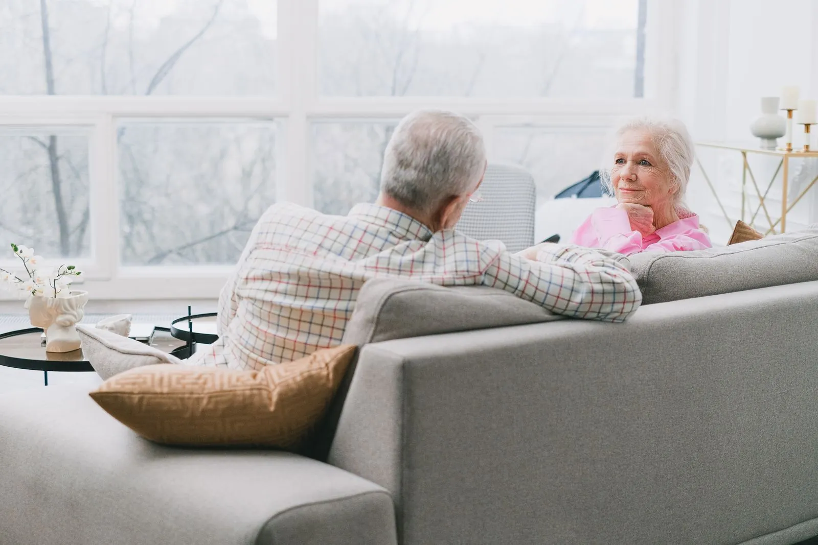 An older couple relaxing together in a bright living room
